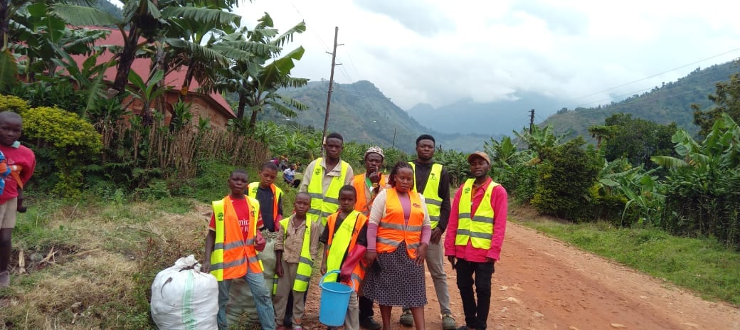 Volunteers collecting waste along a community road
