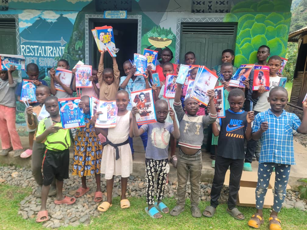 Children with new exercise books during a school support drive