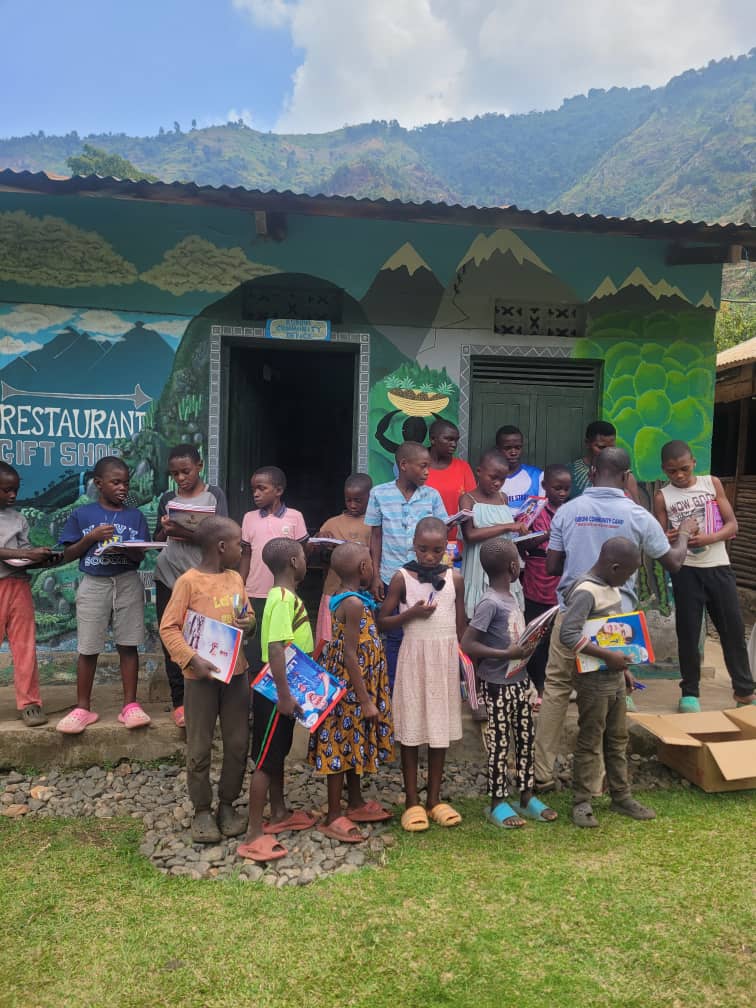 Children receiving school materials in a hillside community